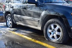 All four tires on this Jeep Cherokee were also punctured, part of recent vandalism at the MTA parking lot in Cold Spring. (Photo by M. Turton)
