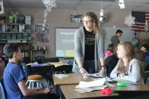 Peer mentor and Haldane 11th-grader Addie Westerhuis, standing, facilitates a lesson on bullying and friendships with Ellis Osterfeld, left, and Genna Sposet.