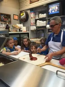 Mike Procopio of Cold Spring Pizza demonstrates the pie craft for the girls (photo provided)