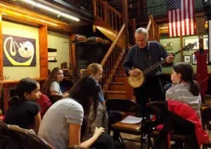 Travis Jeffrey goes over lyrics with some of the Rivertown Kids.   (Photo by Markie Baylash)