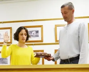 WithâhelpâfromâMayorâTomâCorless,ânewâNelsonvilleâTrusteeâDanielleâPackâMcCarthyâtakesâtheâoathâofâofficeâAprilâ20.
