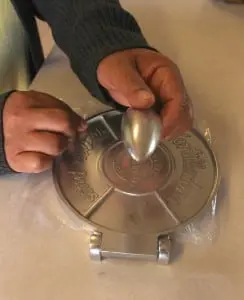 Eva Rojas uses a tortilla press in her Cold Spring kitchen.
