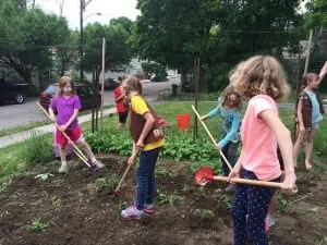 Members of Brownie Troop 1605 are seen here planting the Inspiration Garden for the Philipstown Food Pantry; the garden and food pantry are located at First Presbyterian Church, 10 Academy Street in Cold Spring. (Photo by Jennifer Gilleo)