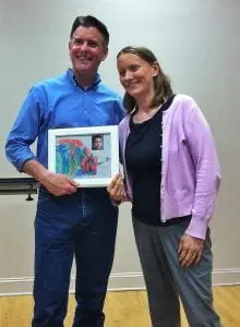 Anna Youatt, co-founder of Tick Free Beacon, presents former state Sen. Terry Gipson with a drawing made by her son, a Lyme disease survivor.