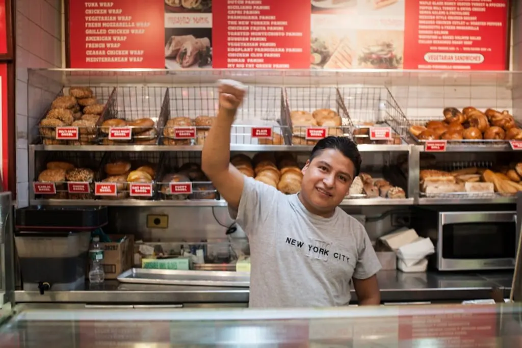 Hot & Crusty pizza maker Nazario G. salutes the occupation of his workplace. (Photo by Eleazar Castillo)