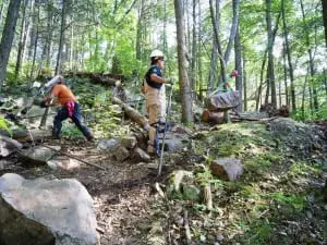 Jolly Rovers at work, "flying" a stone on a highline.