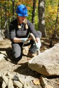 Jolly Rover Valerie Bauer works with a hammer and chisel. A third of the group's volunteers are women.