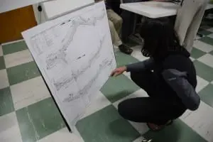 A resident studies charts of the planned drainage work.