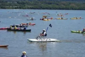 Kayakers escort swimmers across the Hudson during a previous running of the Great Newburgh to Beacon Hudson River Swim. (Photo by Michelle Marcus)