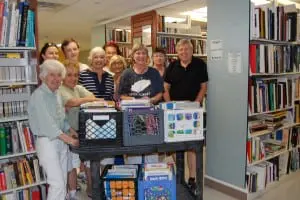 The Friends of the Kent Public Library prepares for their book sale Sept. 4–5.  (Photo by Carol Donick)