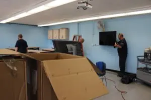 Members of Haldane's custodial crew in August install screens and furniture in the school's second Maker Space. (Photo by A. Rooney)
