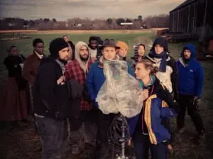 Cast and crew members gather around Justin Liberman, front and center in hat, during the shooting of Tobacco Burn  (photo provided)