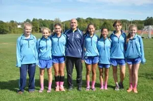 Coach Tom Locascio with the girls' cross-country team, which finished sixth (Photo by Peter Farrell)