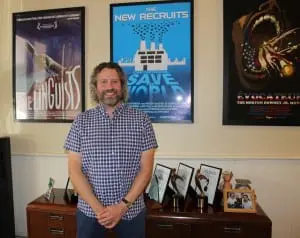 Ironbound Films' Daniel Miller, pictured in front of posters for several of his company's documentaries. (Photo by A. Rooney)