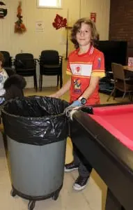Haldane 7th-grader Frank Bentkowski is charge of keeping it clean at the Cedar Street seniors' center, during Service Day.  Photo by A. Rooney 