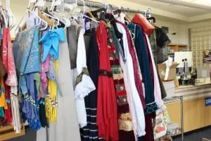 Costumes, largely designed by students, fill a rehearsal rack. (Photo by A. Rooney)