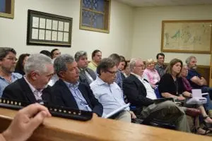 Paul Guillaro (front row second from left) flanked by former planning board chair Barney Molloy and attorney Steven Barshov. (Photo by M. Turton)