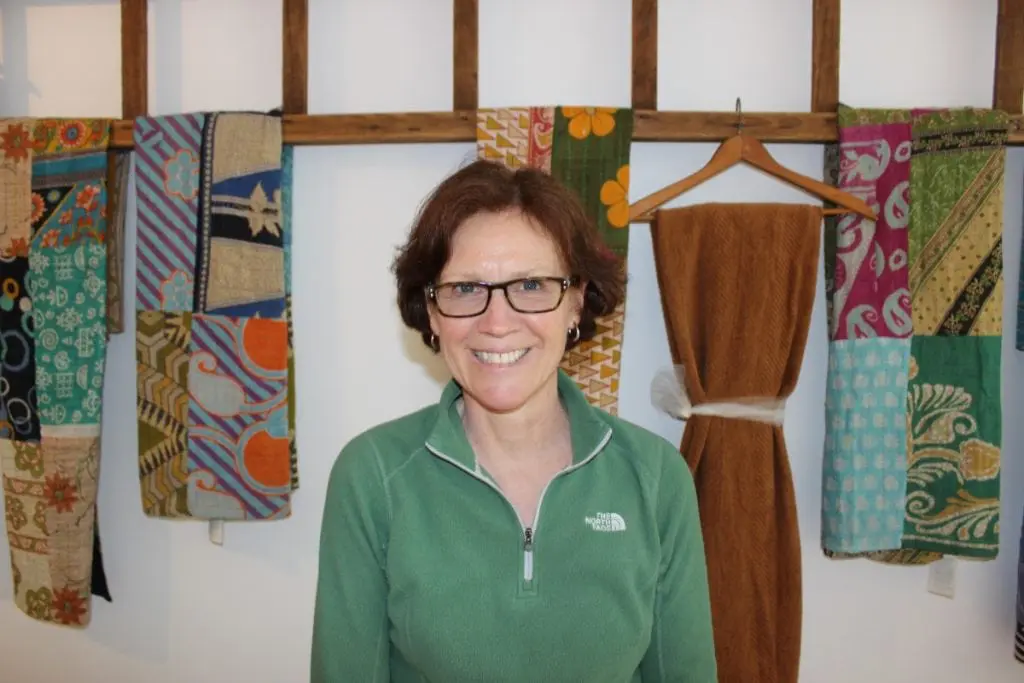 Hudson Natural's Marnie Henricksson, pictured in front of some of the textiles the store features. (Photo by A. Rooney)