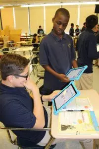 San Miguel Academy students compare "notes" on their tablets. ( Photo by A. Rooney)