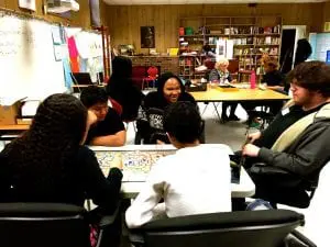Ian Groombridge assists students at Peekskill High School's Success Academy as they analyze board games (photo provided)