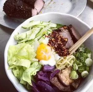 Noodles with smoked brisket, lettuce from Common Ground Farm, purple sweet potatoes, scallions, shiitake mushrooms, cucumbers, and egg. (Photo provided)