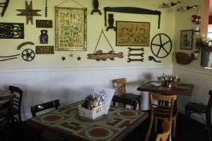The inside dining room at Yankee BBQ is modeled on Cold Spring's Gus's Antique Bar, which closed down in 1980. Table painting is by artist Cassandra Saulter. (Photo by A. Rooney)
