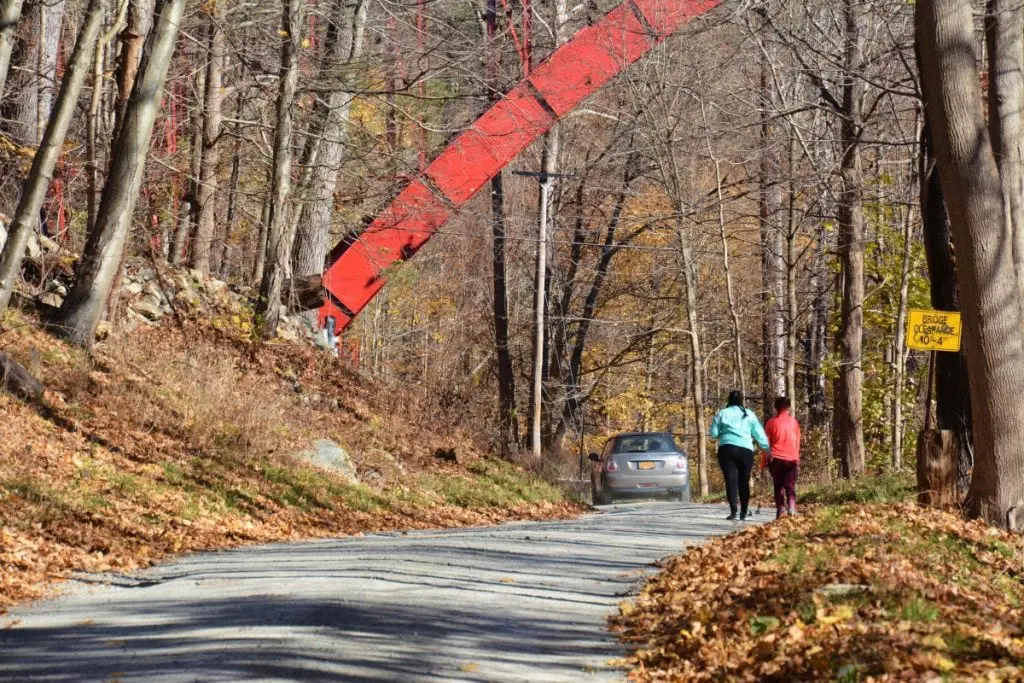 A car sweeps by Megan Oliveri and Grace Razzuno, who came from Long Island, as they head toward Indian Brook Falls. (Photo by L.S. Armstrong)