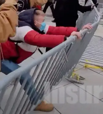 An image from a video taken on Jan. 6 at the Capitol shows a man identified as Gregory R. Purdy Jr. of Carmel pushing on a barricade erected by police.