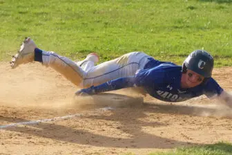 Jeremy Hall hangs on while sliding into third against Putnam Valley.