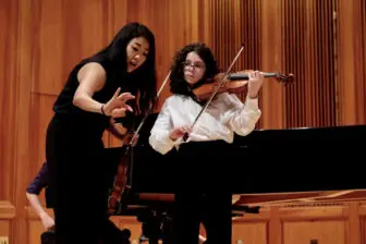 Violinist Kristin Lee works with a Lyra student.