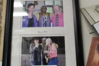 This picture showing Bell with Pete Seeger and an unidentifed man was among the memorabilia hanging on the wall of his barbershop in Beacon. Photo by L. Sparks