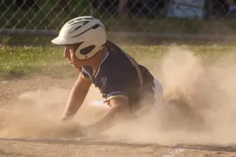 Naim Dika slides into home for the 12U team with the game-winning run on a wild pitch.
