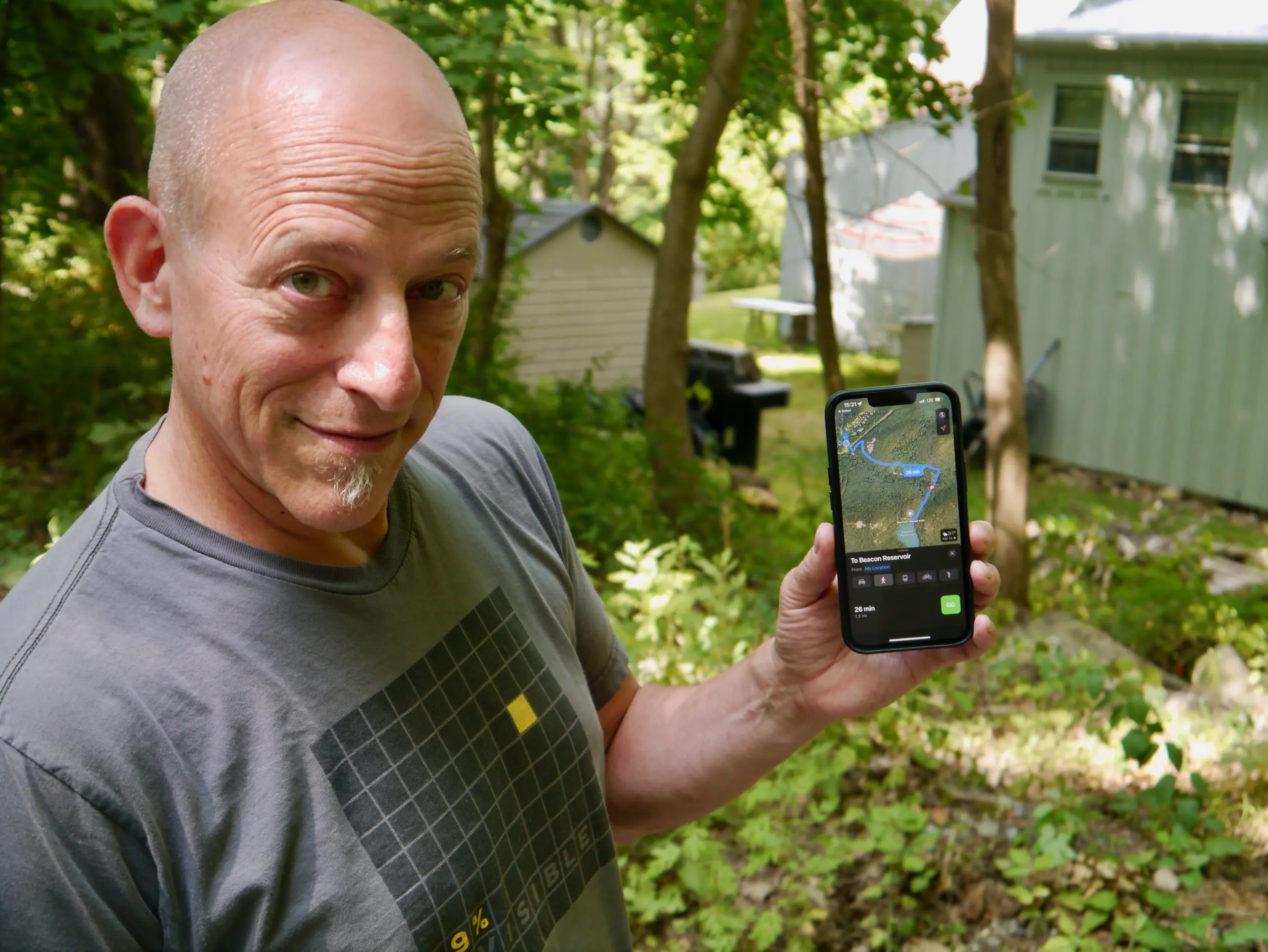 Jeff Battersby, who lives near the private Mount Beacon Monument Road, displays a mapping app that identifies it as a public route to the reservoir. Photo by J. Simms