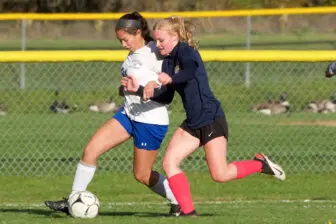Beacon's Hope Cleveringa (right) battles for a ball along the sideline Tuesday against Monticello. Photo by S. Pearlman