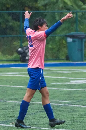 Ryan Eng-Wong celebrated the second of two first-half goals during a rain-soaked, 8-0 victory over Pawling on Oct. 4. Photo by Skip Pearlman