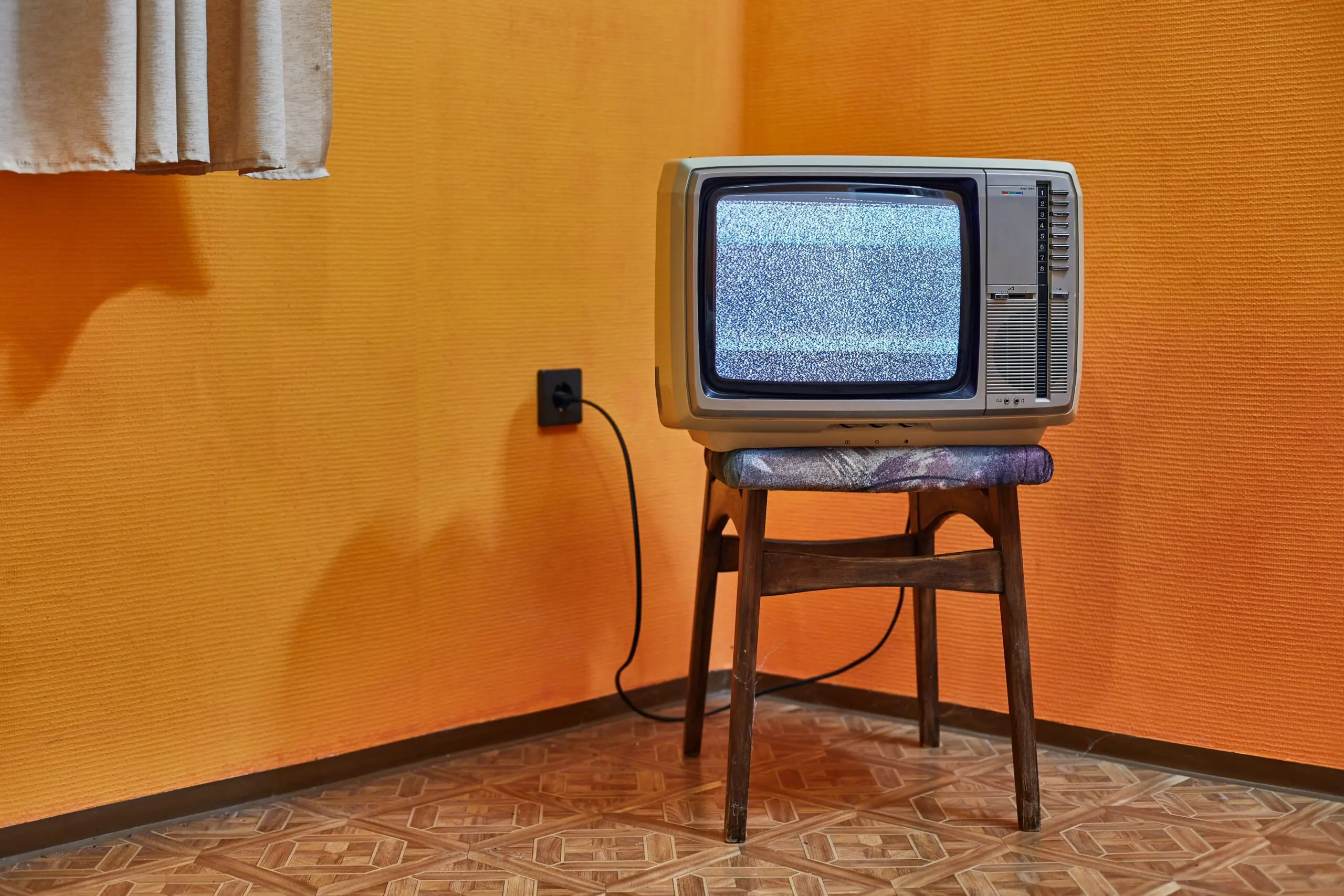 Vintage TV set on a chair in an empty room