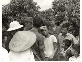 In a photo that McTamaney was able to mail to a relative, Army medics treat local Vietnam- ese villagers during the war. His other photos were kept by the Army. (Photo by Dave McTamaney)