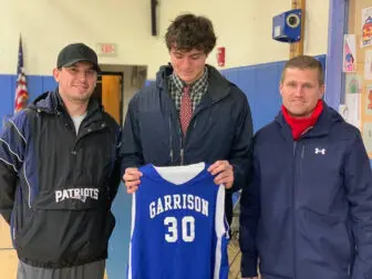 Van Vourliotis (left), the boys' basketball coach at the Garrison Middle School, and Athletic Director Patrick Beckley recently presented Matteo Cervone with his jersey. Cervone, a Garrison graduate, this month scored his 1,000th career point for Haldane High School.