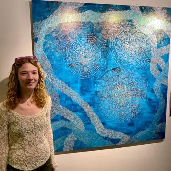 Olivia Flanagan with one of her paintings from this year's program