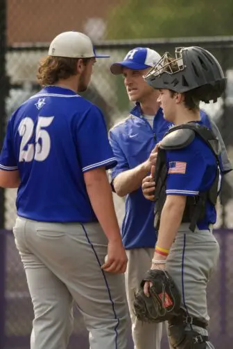 Coach Simon Dudar talks to pitcher Jake Hotaling.