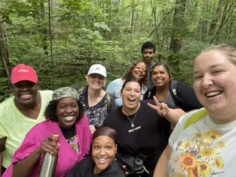 Rosales (center, flashing the peace sign) leading a hike in Fahnestock. (Photo provided) 