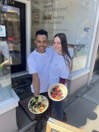 Angel Rodriguez and Katrina Alvez show off two of their dishes outside Healthy In Color.