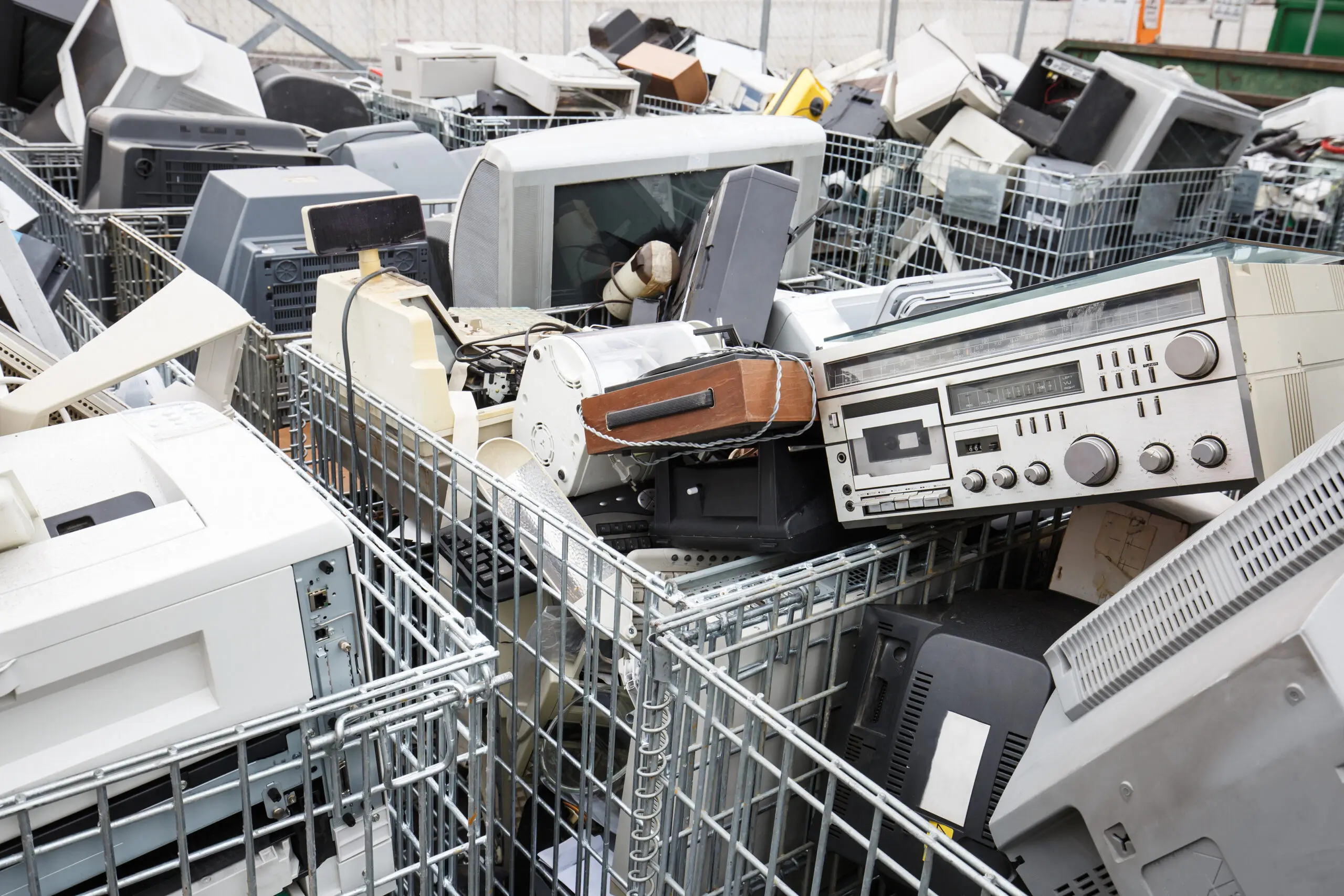 Electronic devices dump site. E-waste disposal, management, reuse, recycle and recovery concept. Electronic consumerism, globalization, raw material source concept.