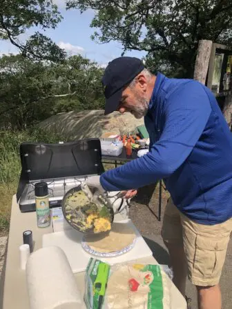 Vlosky prepares a breakfast burrito.