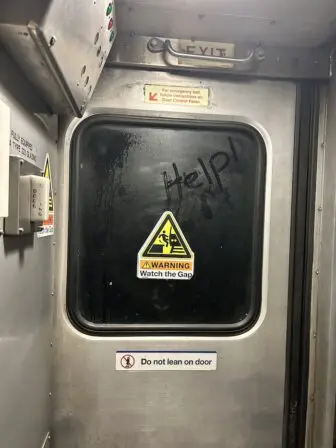 Someone wrote "Help" on the steamed window of a Metro-North train where passengers were trapped for hours because of storm-damaged tracks.Photo by Emily Sheskin