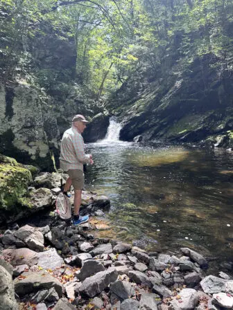 Joey Asher at the spot on Clove Creek where he caught a brown troutNancy Montgomery, William Gipe and Asher posed with their gear before heading out to fish Clove Creek for trout. They got nothing. Photo by Elliott Asher