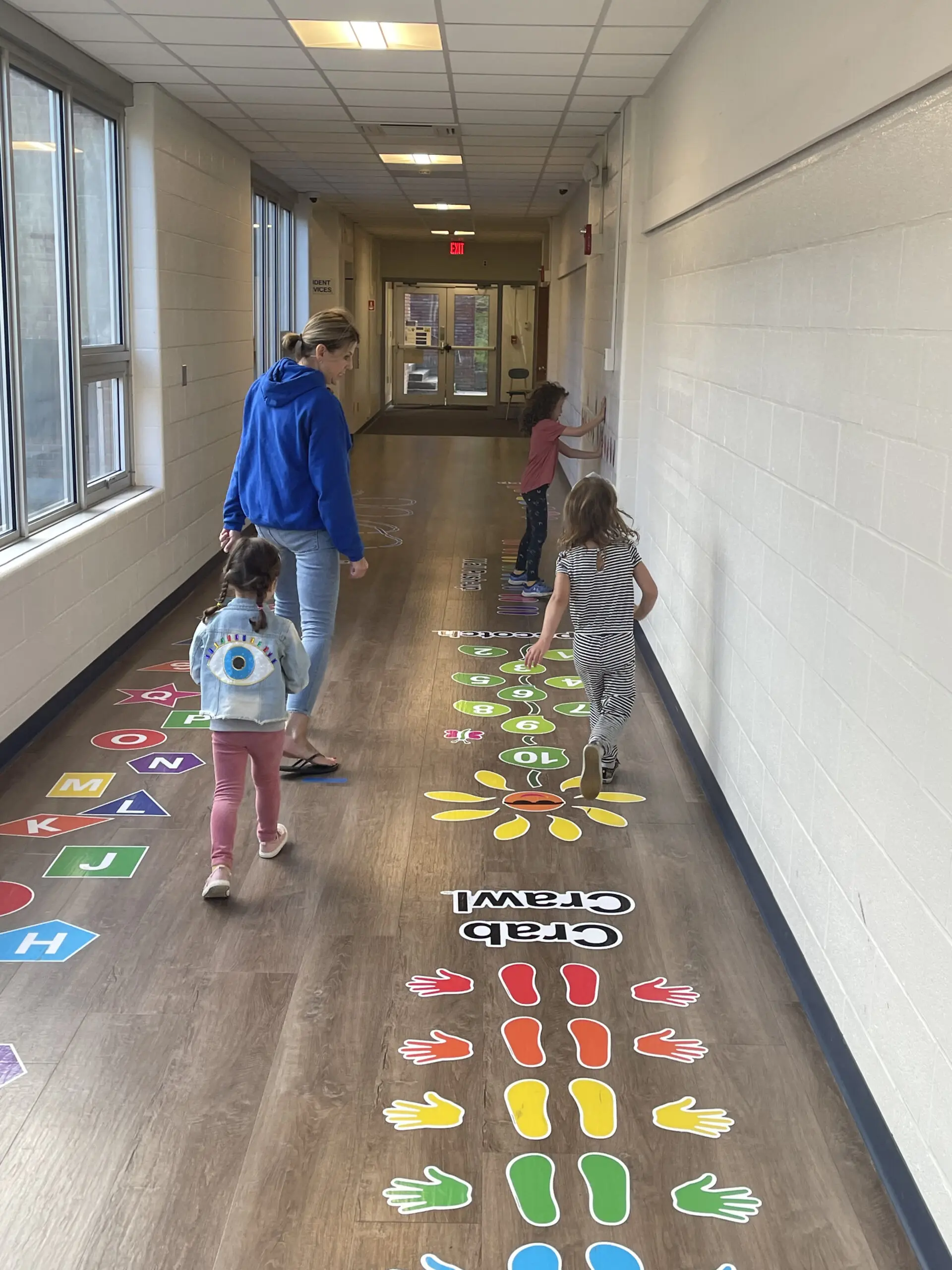 Debbie Earl follows a student along the sensory pathway at the Garrison School. Photo by J. Asher