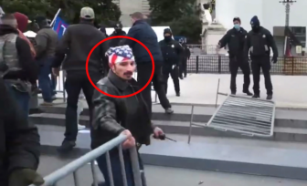 A man identified as William Pepe of Beacon is shown moving a barrier in a photo released by the U.S. Justice Department.