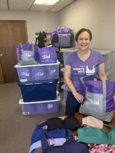 Sarah Dwyer-Shick shows off donated sports bras at her Beacon office.Photo by J. Asher
