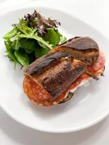 Toasted bread with grilled eggplant, burrata and Milano salami